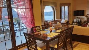 a dining room with a table and chairs and a living room at Melodia Home in Kalymnos