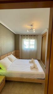 a bedroom with a bed with two towels on it at Apartamento Magic World Neptuno in El Borseral +60 photos