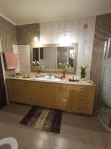 a bathroom with a sink and a mirror at Melodia Home in Kalymnos +72 photos