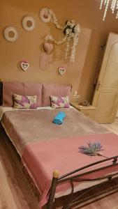a bedroom with a large bed with a pink blanket at Melodia Home in Kalymnos