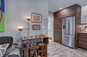 a kitchen with a stainless steel refrigerator and wooden cabinets at Spacious Conveniently Located 1BR in Myers Park in Charlotte