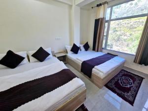 Postel nebo postele na pokoji v ubytování Hotel Aashirwad