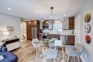 a kitchen with a glass table and chairs at Experience Myers Park in Style in Charlotte