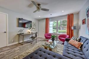 a living room with a blue couch and red chairs at Spacious condo with easy access to Uptown in Charlotte