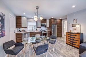 a kitchen and dining room with a glass table and chairs at Chic and Relaxing 1BR in the Heart of Myers Park in Charlotte +26 photos