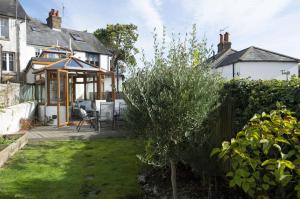 a house with a garden and a patio at Lilac Cottage by Keepers Cottages in Kingsdown