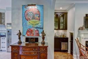 a kitchen with a painting on the wall at Elegant 2BR with Covered Patio in Charlotte +33 photos