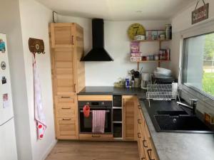 a kitchen with a sink and a stove top oven at St Marc proche plage, 2 chambres in Saint-Nazaire