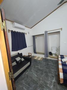 a living room with a couch and a toilet at Seromue in Diego Suarez