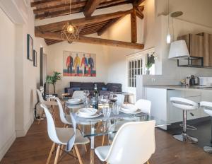 a dining room and kitchen with a table and chairs at Palazzo Luparelli Boutique Apartment in Colle di Val d'Elsa