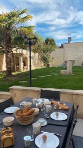a black table with food and bread on it at L'envie Eymet in Eymet