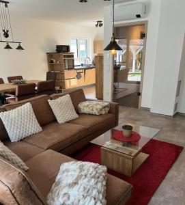 a living room with a couch and a kitchen at Ferienhaus Am Nationalpark 8A in Klausdorf Mecklenburg Vorpommern