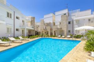 a villa with a swimming pool in front of a building at Lucrezia - Relax, Piscina, Barbeque e Wi-Fi in Nardò