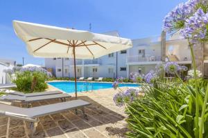 a patio with an umbrella and a swimming pool at Lucrezia - Relax, Piscina, Barbeque e Wi-Fi in Nardò