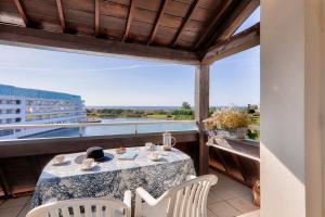 アルゾンにあるAppartement vue mer à 400m de la plage du Fogeoの眺めの良いバルコニーにテーブルと椅子が置かれている