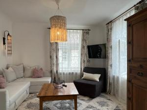 a living room with a couch and a table at Hercoga Jekaba Apartaments in Kuldīga