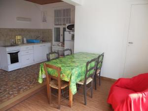 a kitchen with a table and chairs in a room at soulac sur mer maison proche du marche in Soulac-sur-Mer