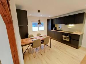 a kitchen and dining room with a wooden table and chairs at Dein Eifelhaus in Langenfeld