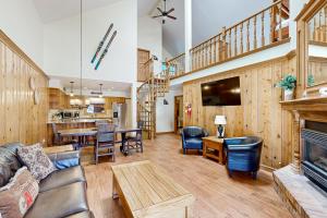 a living room with a couch and a fireplace at Snowfire 308A in Angel Fire