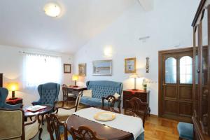 a living room with a blue couch and chairs at Apartment Sara in Pirovac