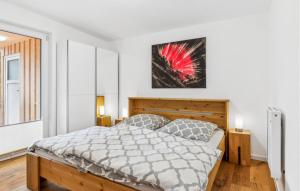 a bedroom with a bed and a picture on the wall at 1 Bedroom Cozy Home In Schwerin in Schwerin