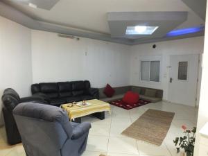 a living room with a couch and a table at Hermon Garden Apartment in Majdal Shams