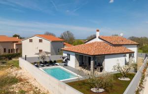 a house with a swimming pool in a yard at Gorgeous Home In Jursici With Wifi in Juršići