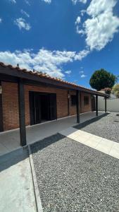 a red brick building with a walkway in front of it at Casa na Praia - 180m do mar in São Francisco do Sul