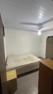 a bedroom with a bed in the middle of a room at Casa na Praia - 180m do mar in São Francisco do Sul +11 photos