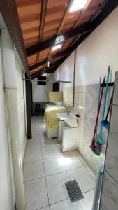 a bathroom with a bed and a sink and bats at Casa na Praia - 180m do mar in São Francisco do Sul