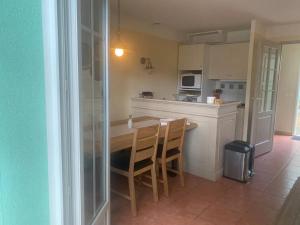 a kitchen with a table and chairs in a room at Maison avec jardin à Lacanau – 54 m² in Lacanau