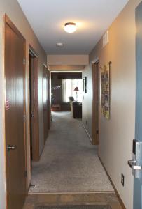 a corridor of a hallway with doors and a room at 2 Bedroom Lower Duck Lake Condo in Eagle River