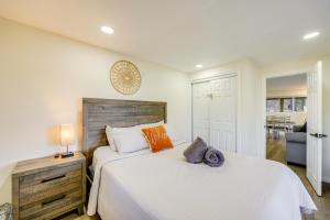 a bedroom with a large white bed with orange pillows at Spacious Family Home with Deck in Lake Arrowhead! in Lake Arrowhead