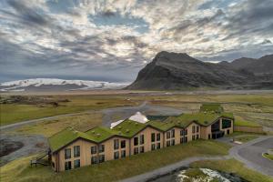 eine Luftansicht eines Hauses mit einem Berg in der Unterkunft Hótel Jökulsárlón - Glacier Lagoon Hotel in Gerdi