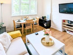 a living room with a couch and a table at 7 Goodrington Lodge in Paignton