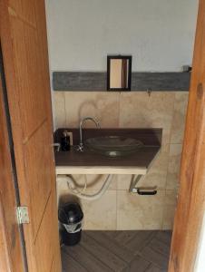a bathroom with a sink in a room at Casa Água da Rocha in Itaguaí