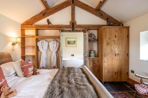 a bedroom with a bed in a room with wooden ceilings at 8lacksmith's Shop in York