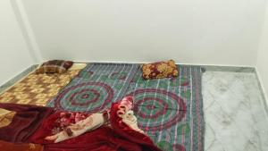 a bed with a quilt on top of it at Karan homestays in Prayagraj