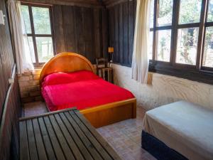 a bedroom with a bed with a red blanket at Pousada Gendra's in Imbituba +93 photos