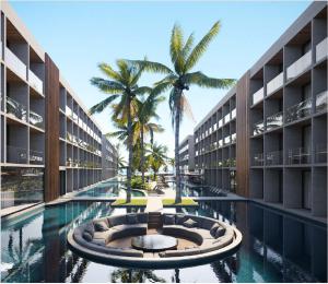 un edificio con una piscina con una palma di fronte di Porto Alto Resort - GAV a Porto De Galinhas