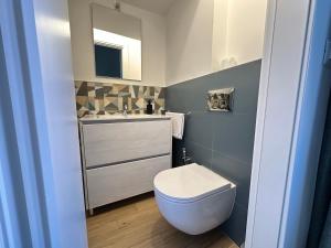 a bathroom with a white toilet and a sink at Luxury House Belgrande in Milan +21 photos