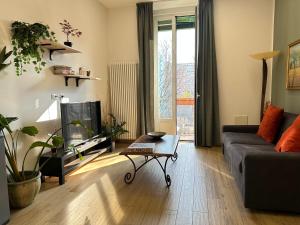 a living room with a couch and a tv at Luxury House Belgrande in Milan