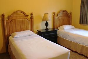 a bedroom with two beds and a table with a lamp at 2 Bedroom Accessible condo, #114 Wild Eagle Lodge in Eagle River +29 photos