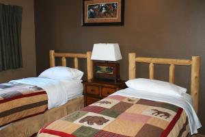 a bedroom with two beds and a lamp on a night stand at 2 Bedroom Lower Lakefront Condo, Wild Eagle Lodge #116 in Eagle River