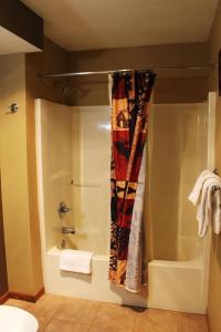 a bathroom with a shower and a shower curtain at 2 Bedroom Lower Lakefront Condo, Wild Eagle Lodge #116 in Eagle River +31 photos