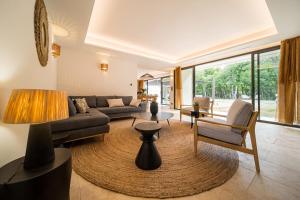 a living room with a couch and a table at Stone villa with heated pool in Gordes in Gordes
