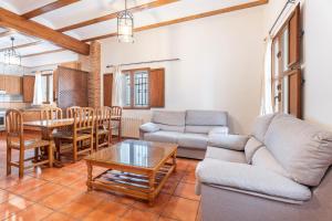 a living room with a couch and a table at Cueva De La Portería in Chulilla
