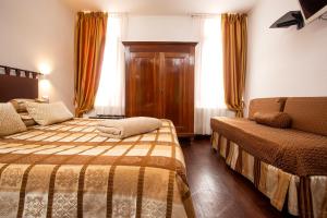 Cama ou camas em um quarto em Albergo Marin