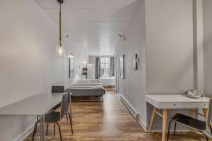 a room with white walls and a table and chairs at Initial 303 Québec in Quebec City