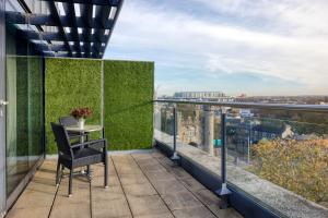 a balcony with a table and a view of the city at Hilton Dublin Kilmainham in Dublin